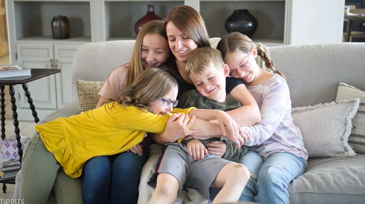 four kids hugging their mom