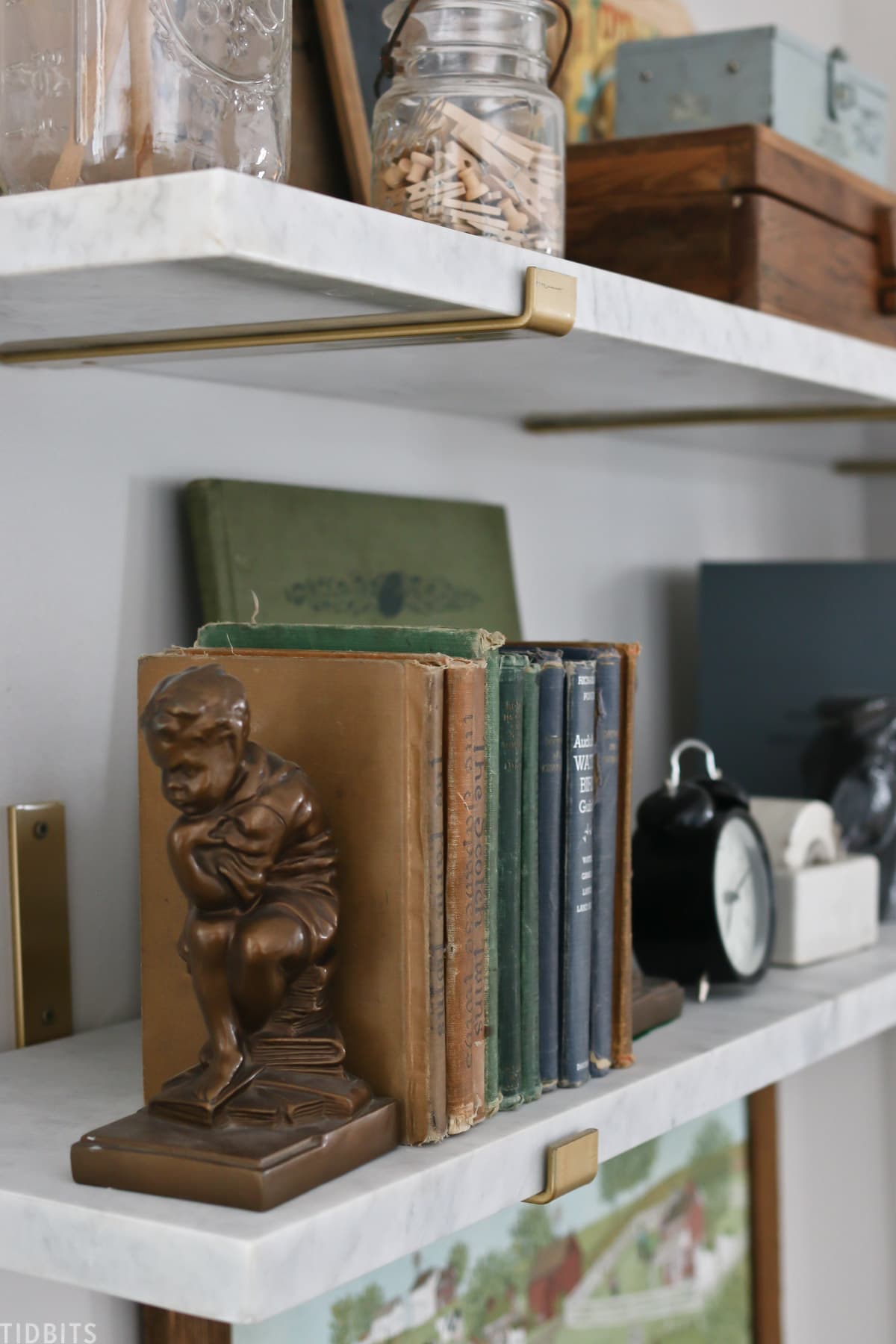 Bookends holding up a bookshelf on a floating shelf
