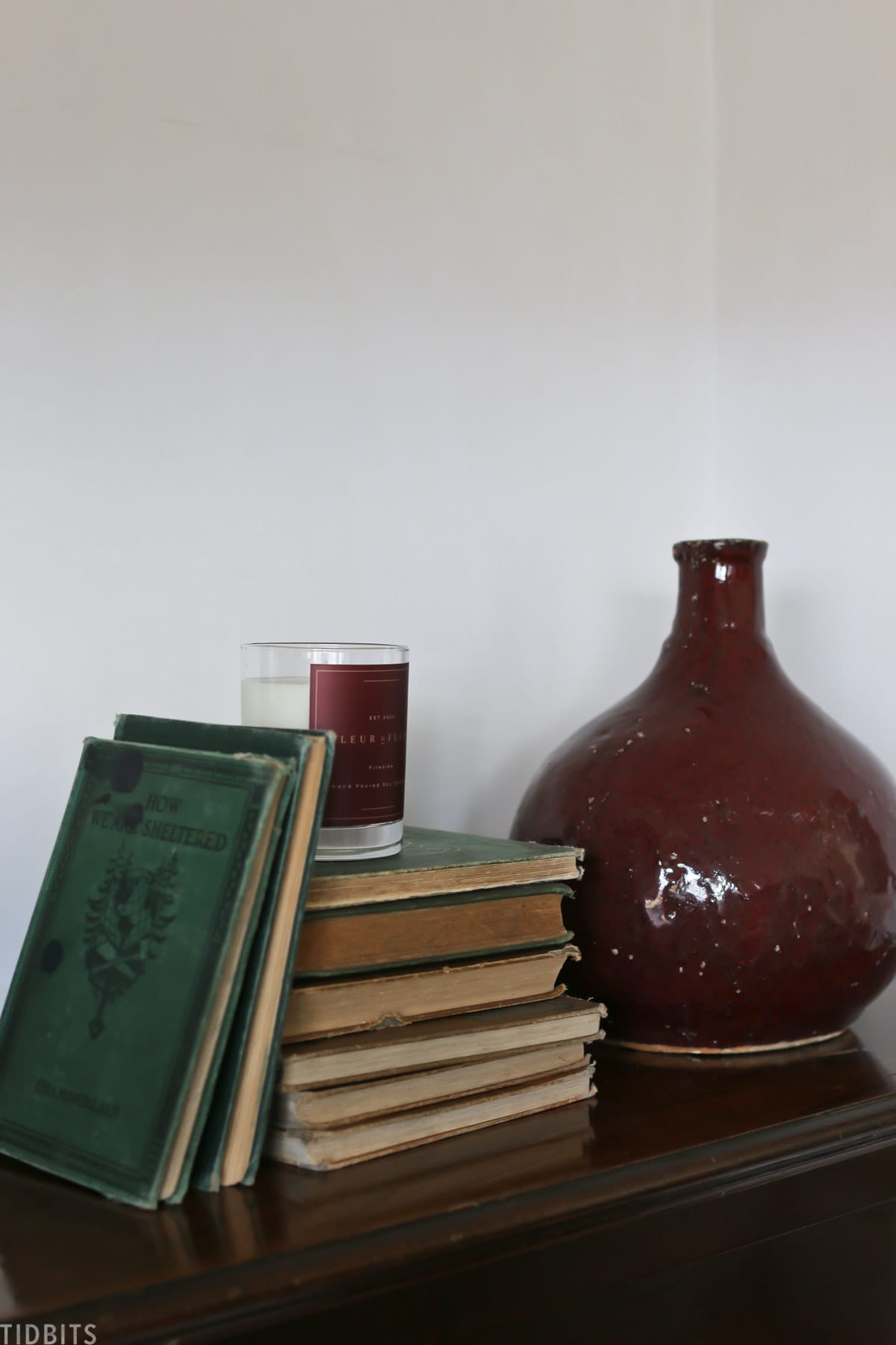 mantel decor books candle and vase