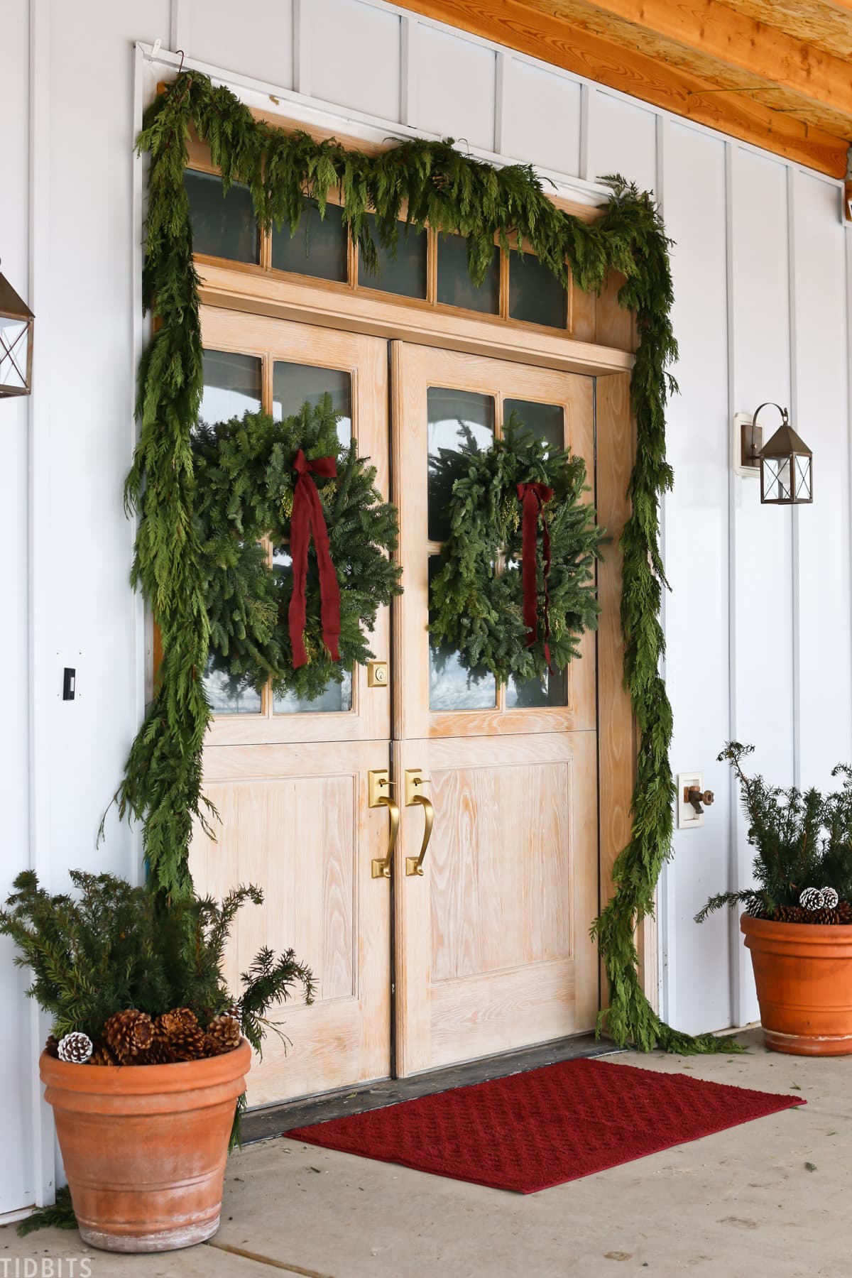 Front porch for Christmas with garland and wreaths