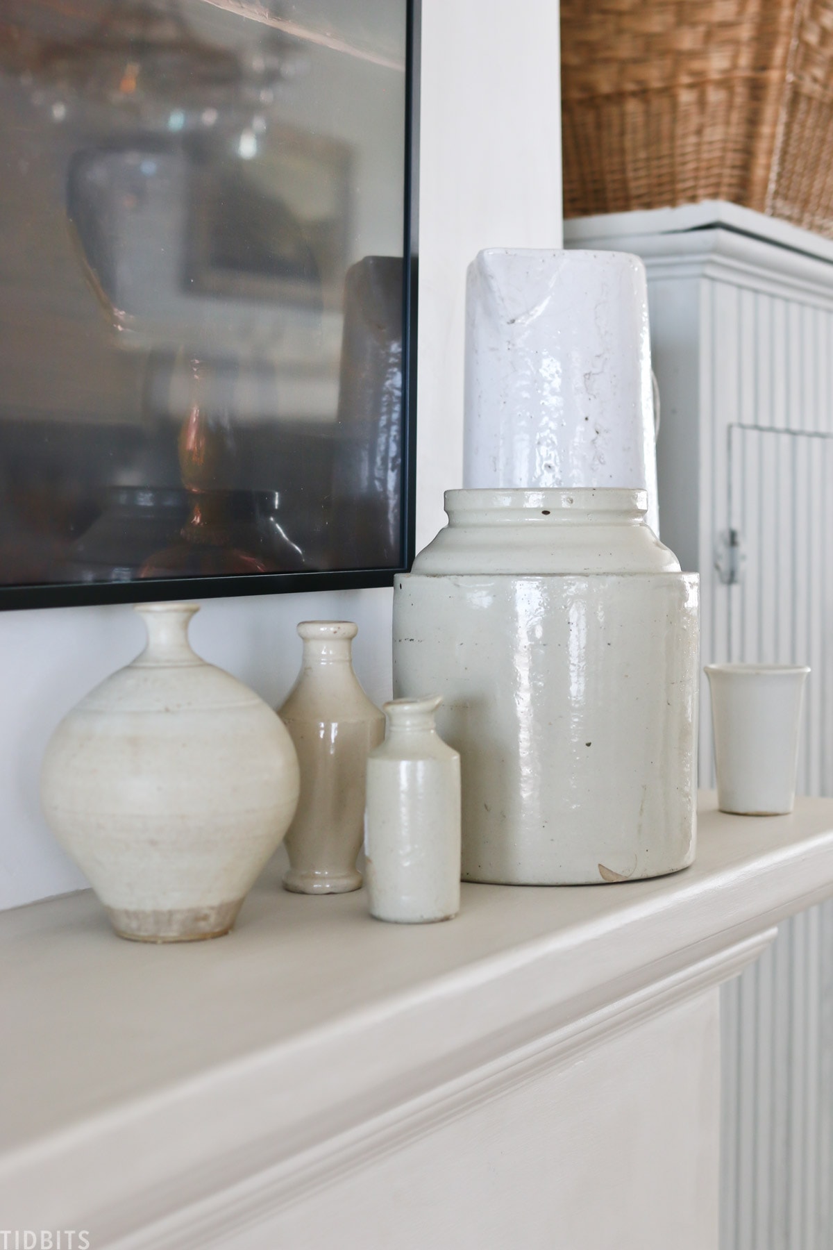 Collection of white pottery on fireplace mantel