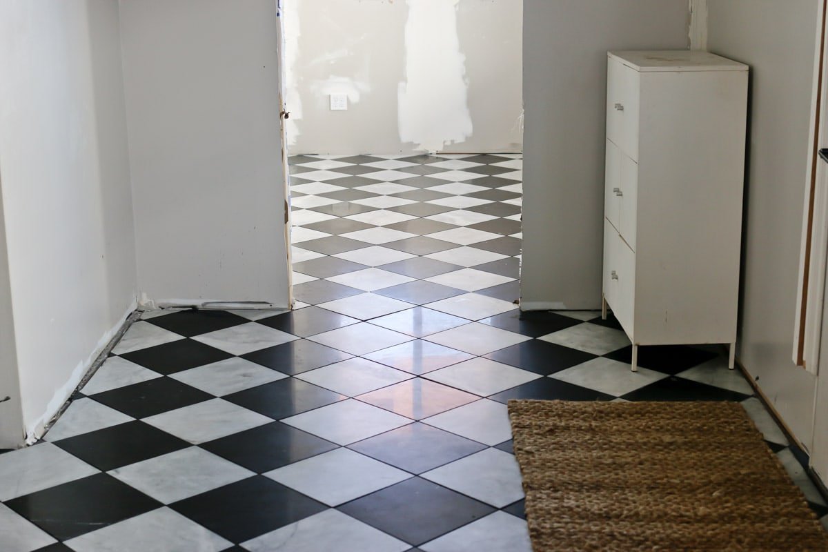 black and white checkered flooring installed in mudroom