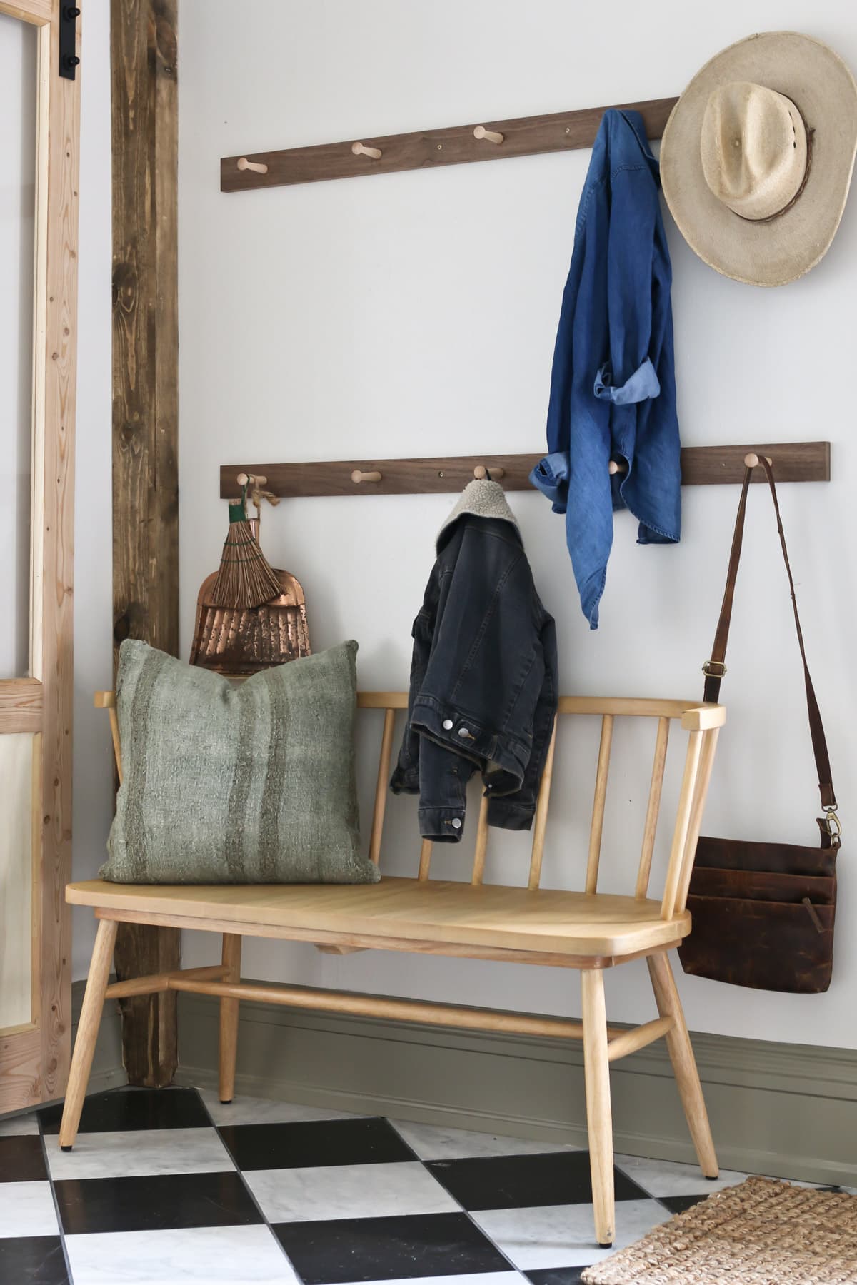 Bench in mudroom with shaker pegs