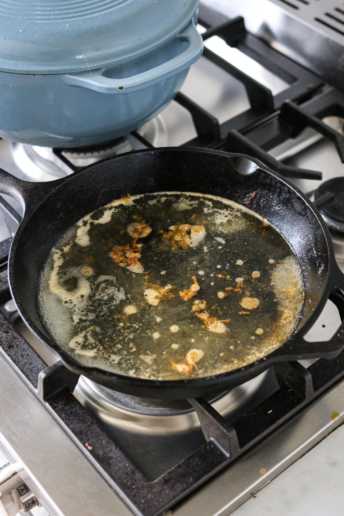 Cleaning a heavily soiled cast iron pan in boiling water