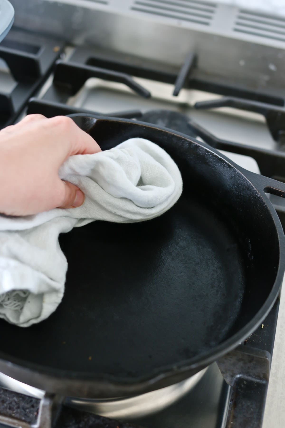 wipe down a cast iron pan with oil while hot.