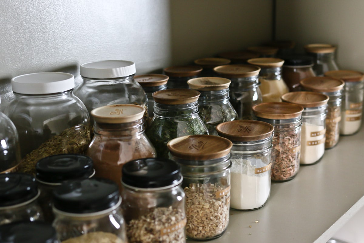 jars with wood lids and herbs