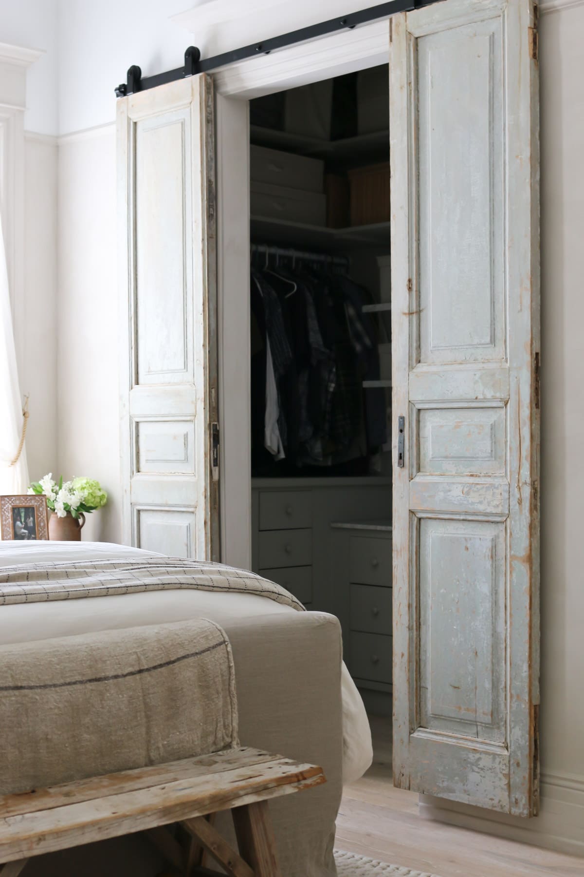 European farmhouse master bedroom with vintage doors