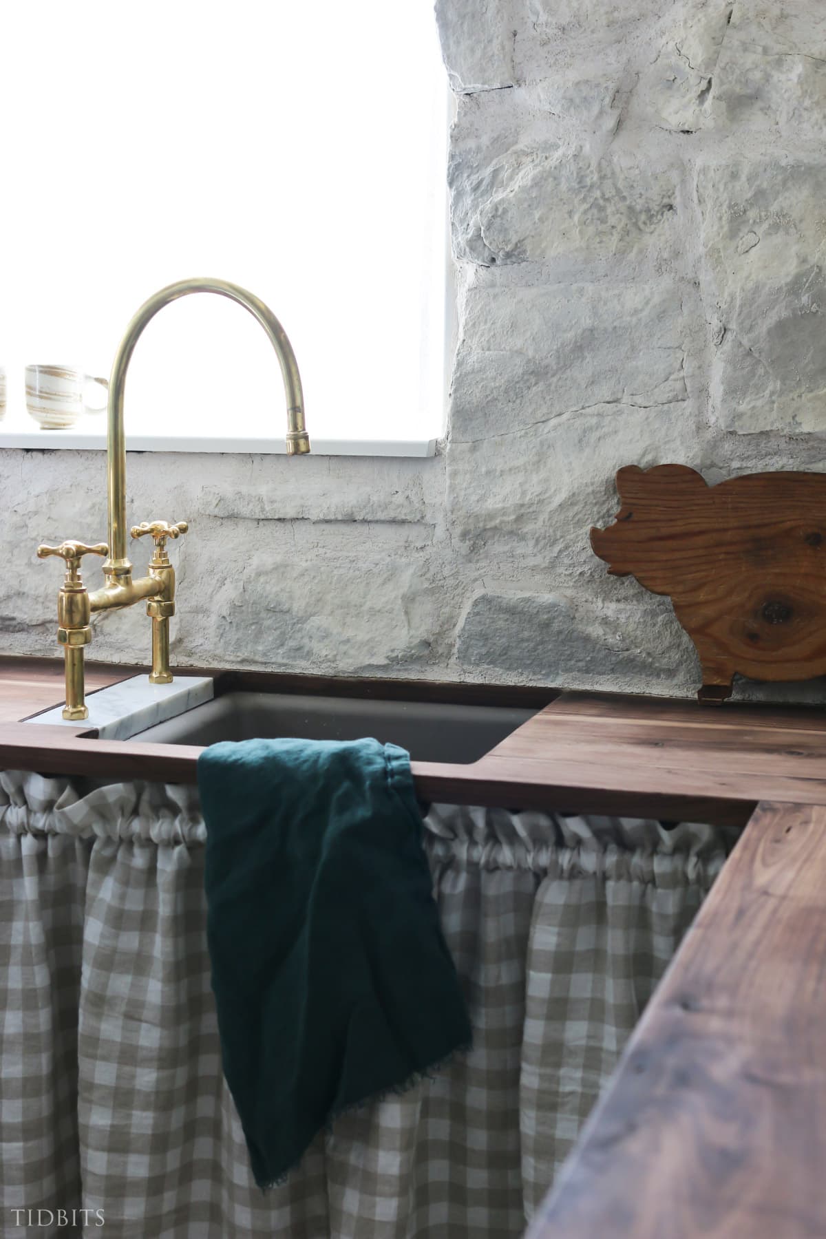 Brass faucet and butcher block counter top