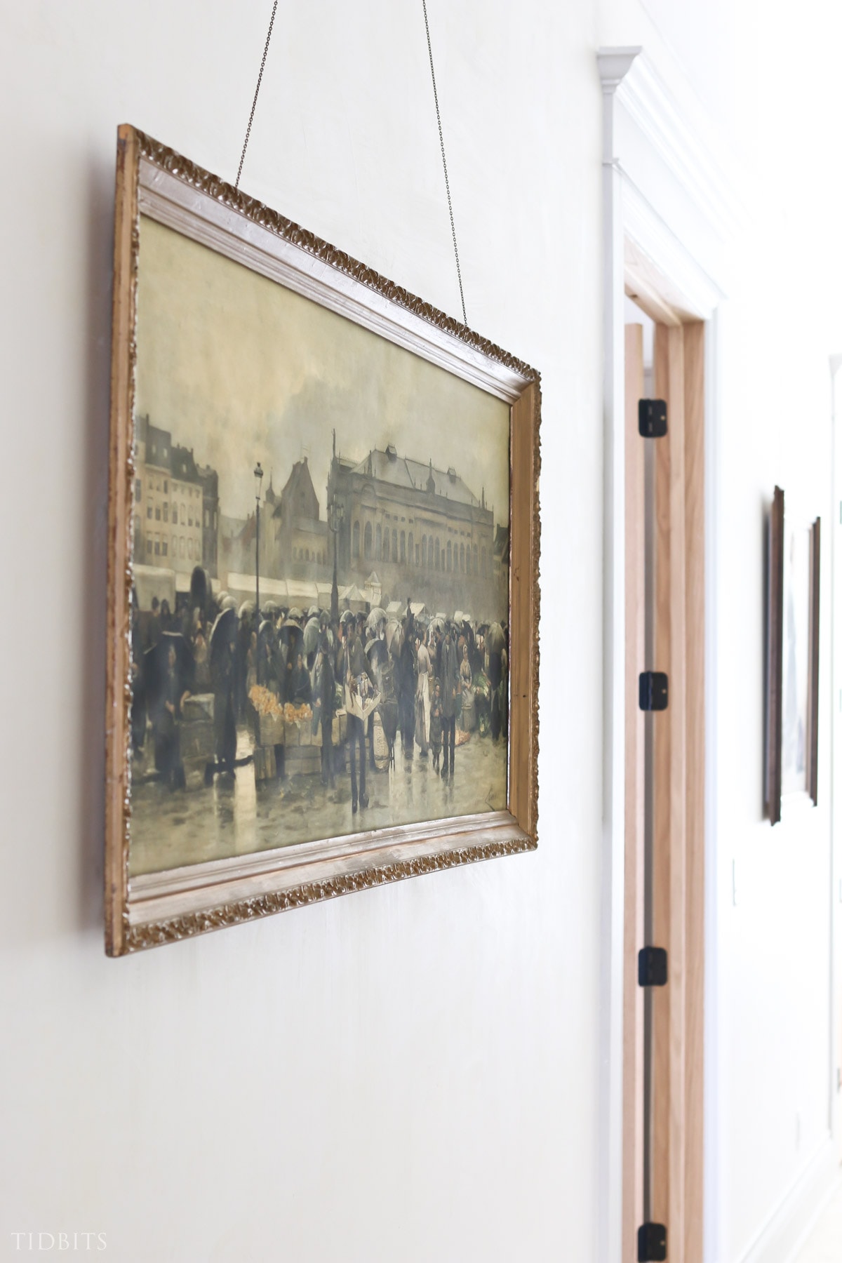 Large wall art idea of a picture of a market scene hanging in hallway