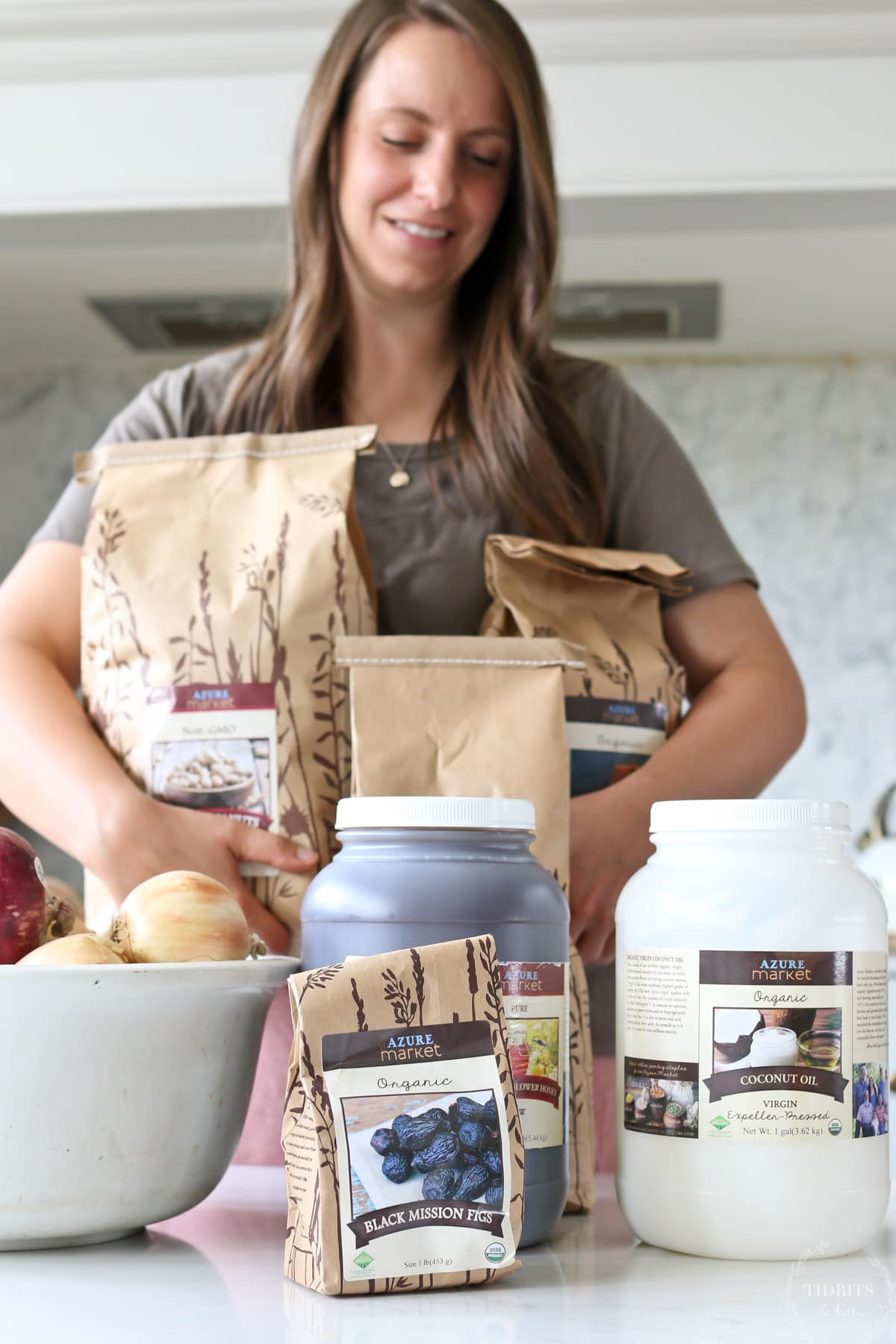 A woman holds packages of healthy, organic food