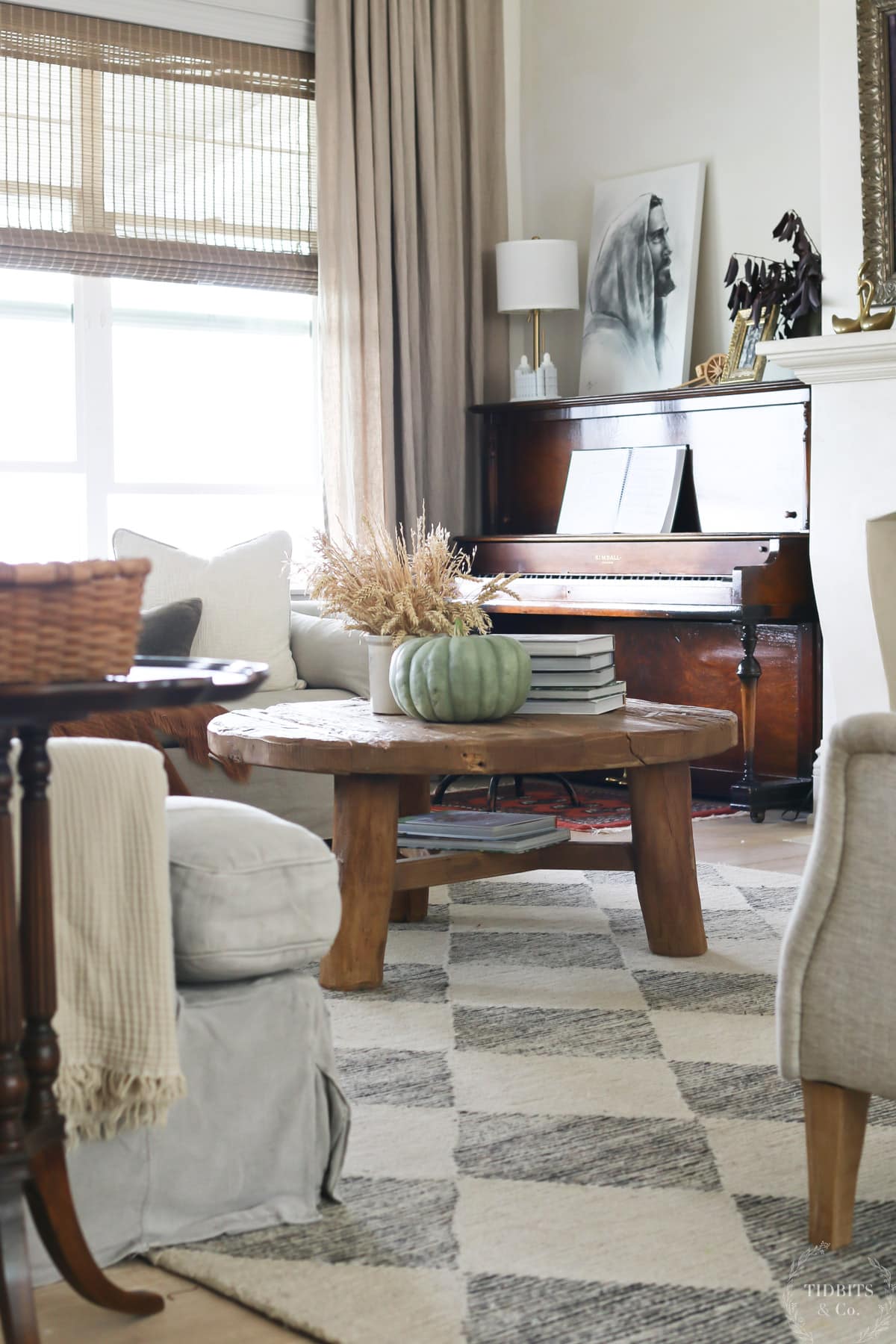 A living room decorated for fall with neutral pillow and throw blankets