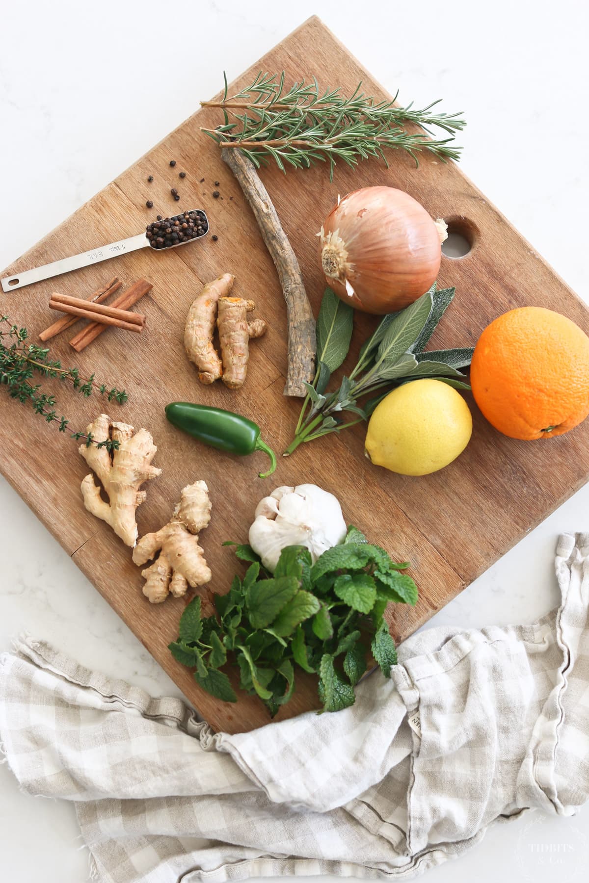 Assorted vegetables, herbs, fruits and spices on a wood cutting board