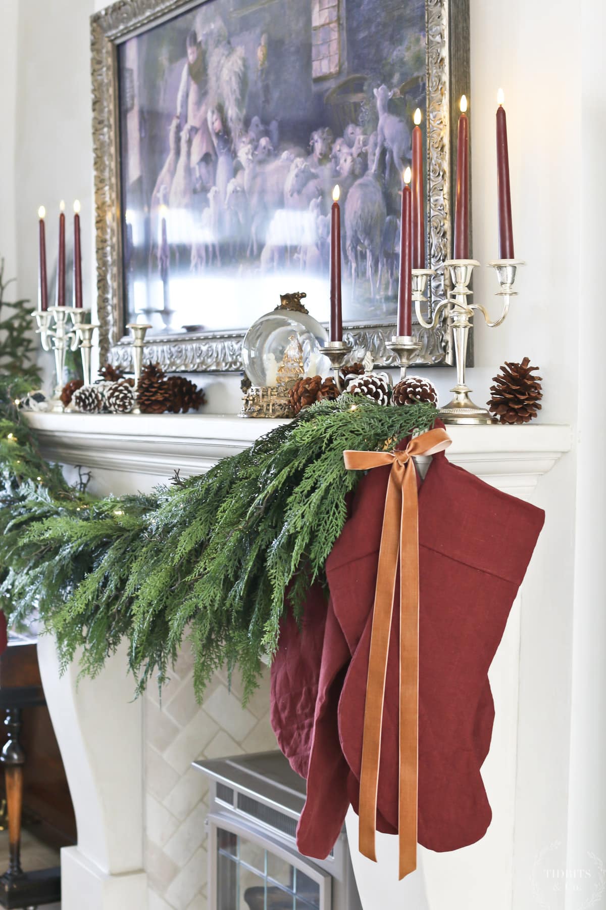 Stockings and garland on a decorated Christmas mantel