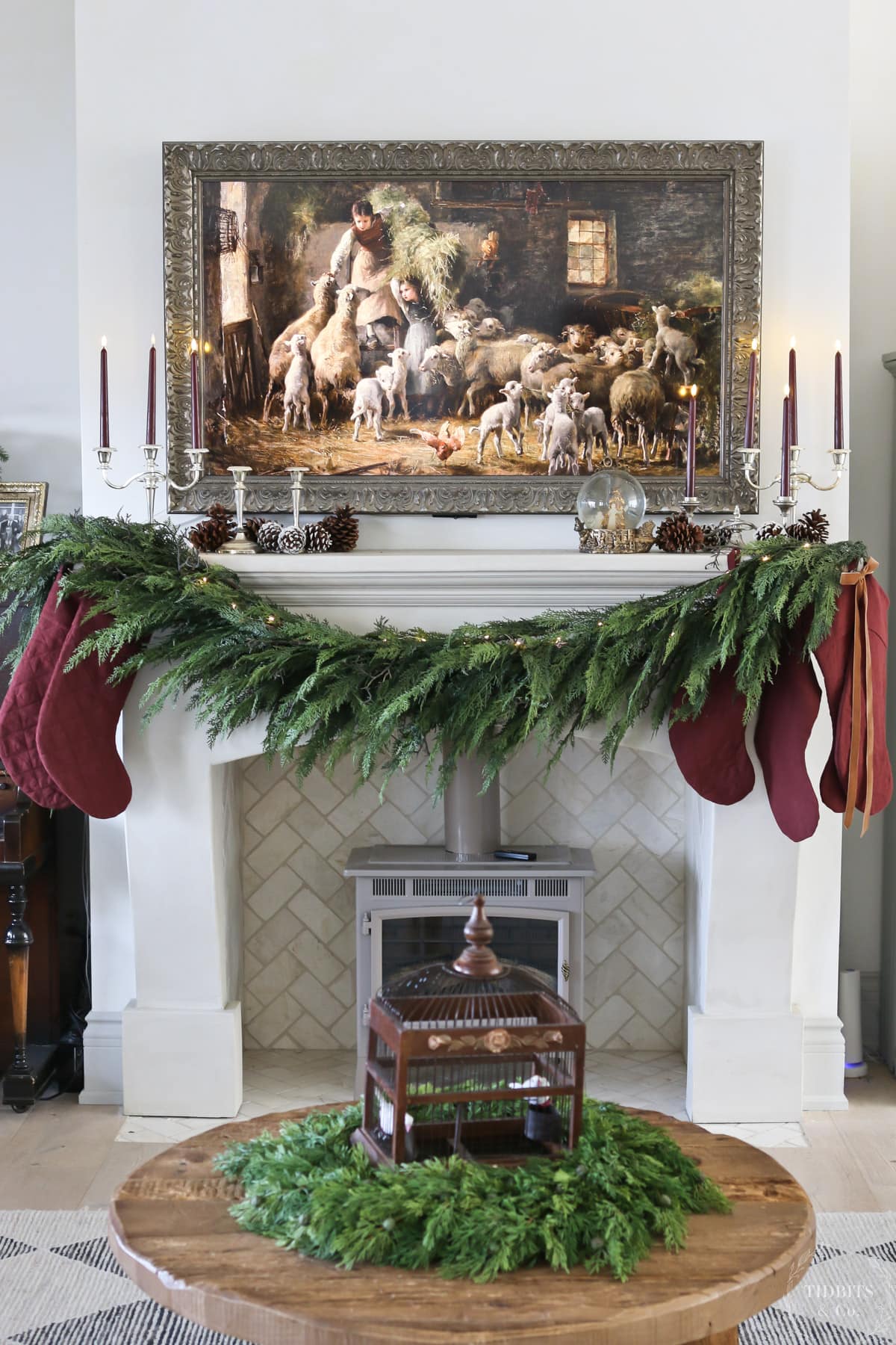 A faux cedar garland and stockings on a fireplace mantel