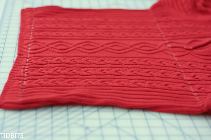Two lines of markings on a red sweater to be make into pillow cover