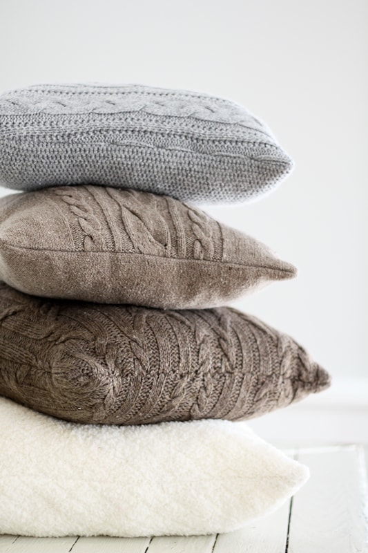 Cozy up your home with re-purposed sweater pillows - plus the key to avoiding wavy seams when sewing with knitted fabric.