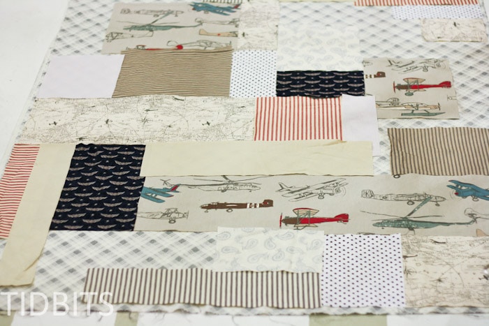 Cut pieces of fabric laid out to design easy quilt