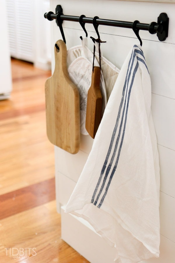 Hang a rod on the peninsula for a quick reach to cutting boards and hand towels.