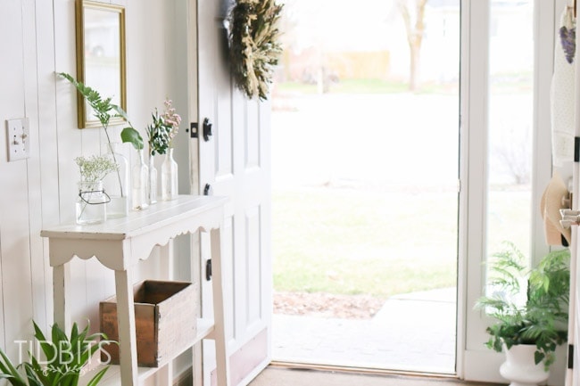 Spring Home Tour by TIDBITS - Freshen up an entry way with free or on a dime greenery placed inside jars.