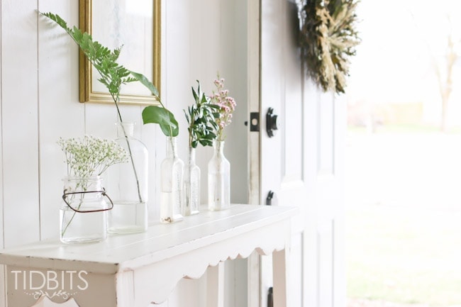 Spring Home Tour by TIDBITS - Freshen up an entry way with free or on a dime greenery placed inside jars.