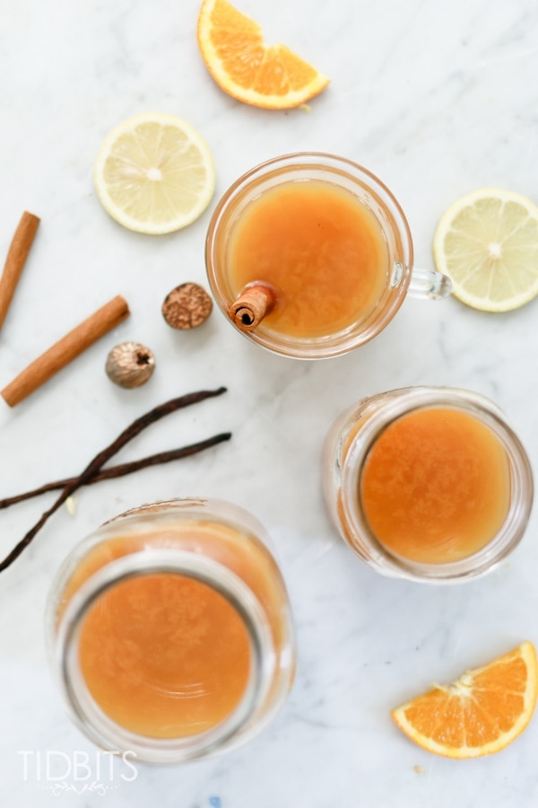 Wassail in a glass cup with cinnamon sticks