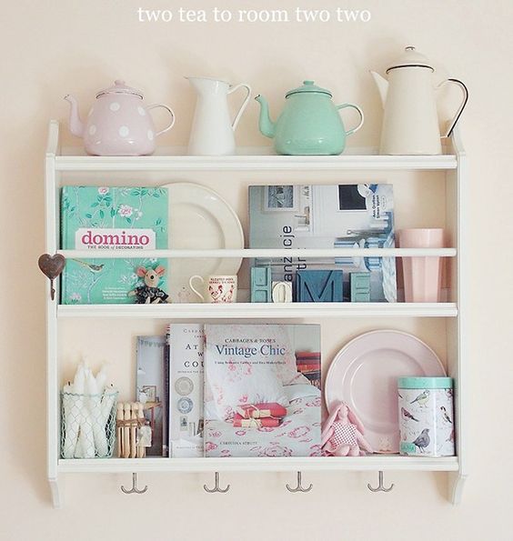 An open shelving unit holds dishes, magazines and decor