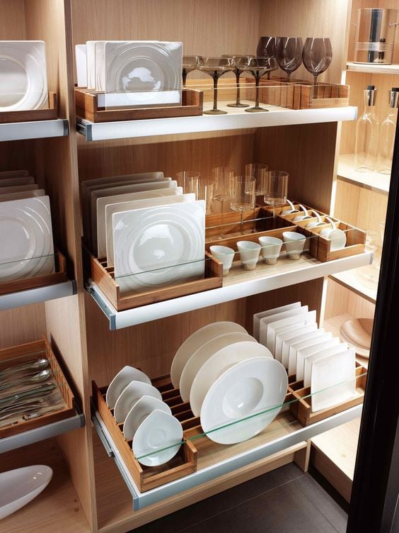 Pull out shelving holds well organized dishes in neat rows