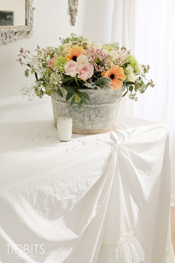 DIY Ruffle Tablecloth from cotton sheets - turn your inexpensive fold up tables into lovely accent tables.
