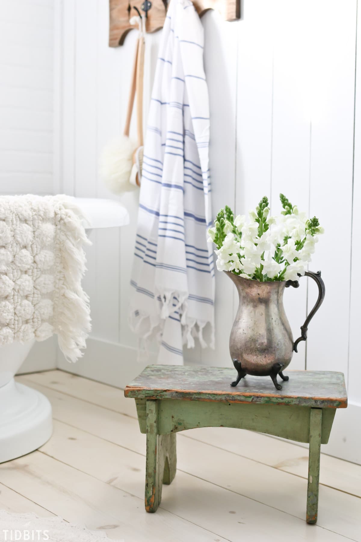 Cottage Farmhouse Spring Bathroom Refresh green wooden table with spring flower decor