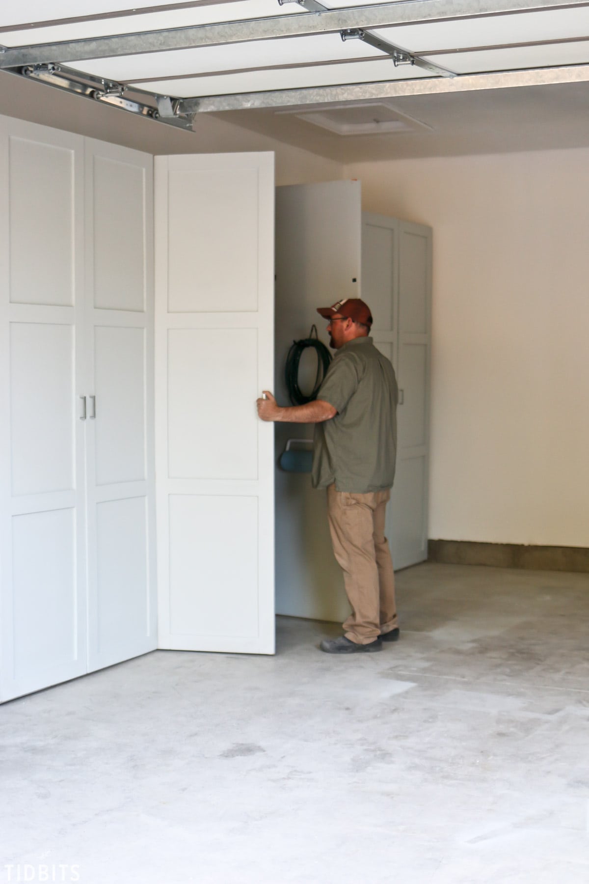 man opening garage cabinets