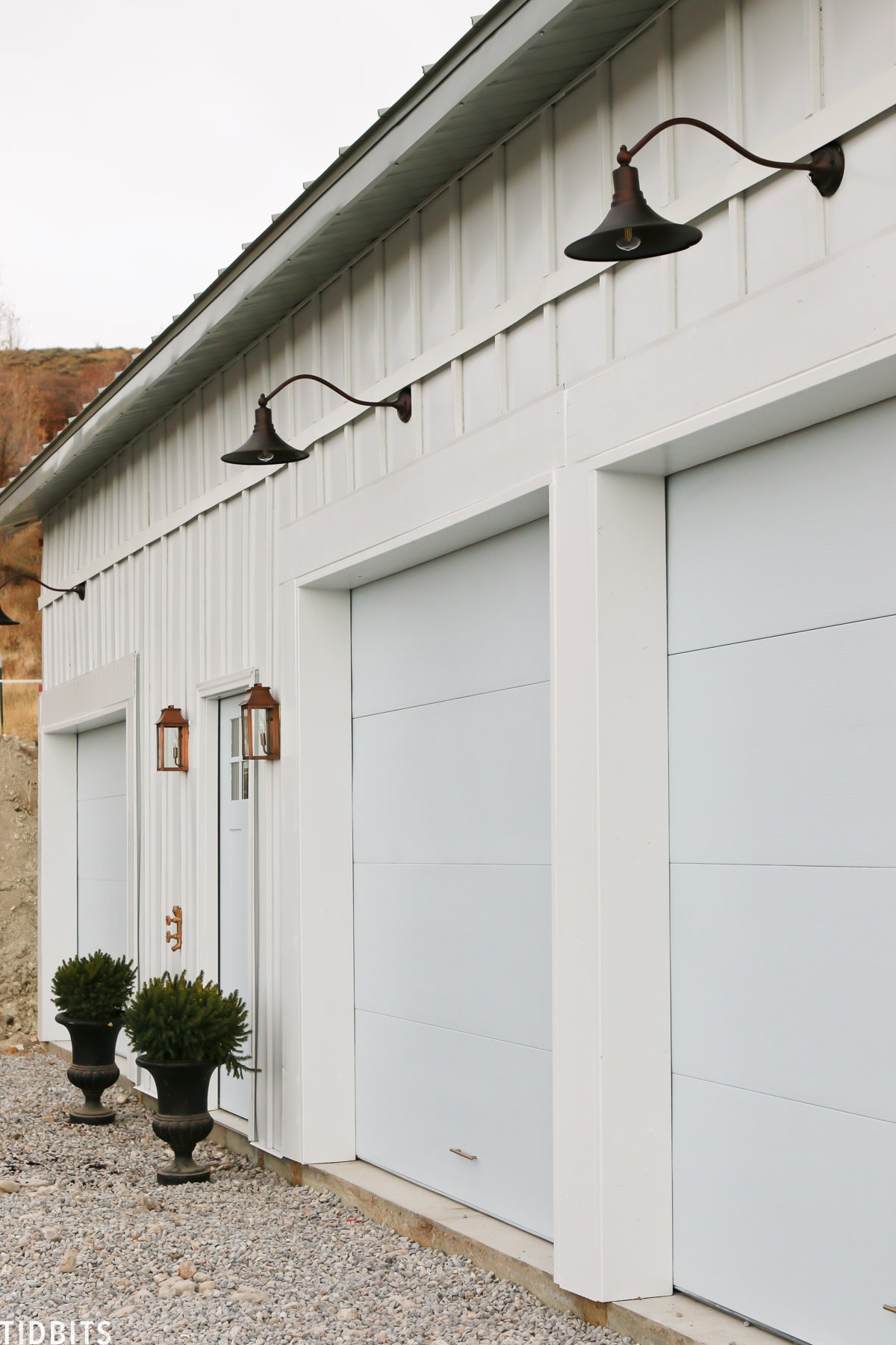 Painted garage doors, steel siding and roofing, pole barn home. 
