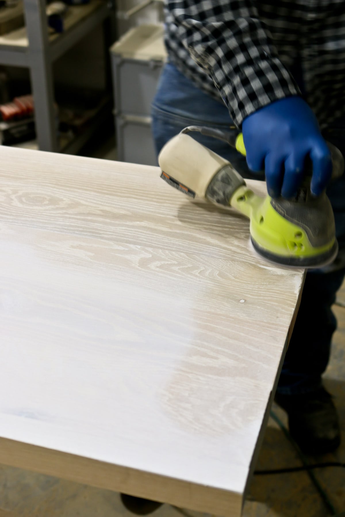sanding the plank of wood