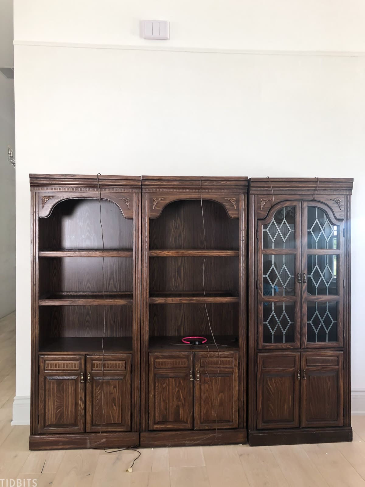 three antique bookshelves placed side by side