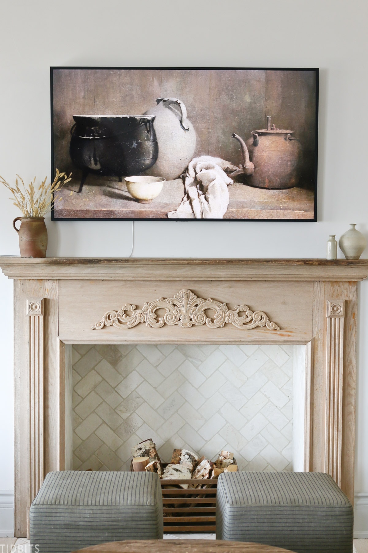 faux fireplace mantel with wood placed inside fireplace and vintage painting above mantel