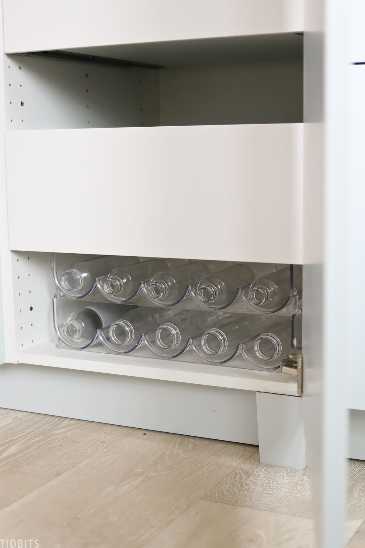 reusable water bottles stored in bottom kitchen drawer