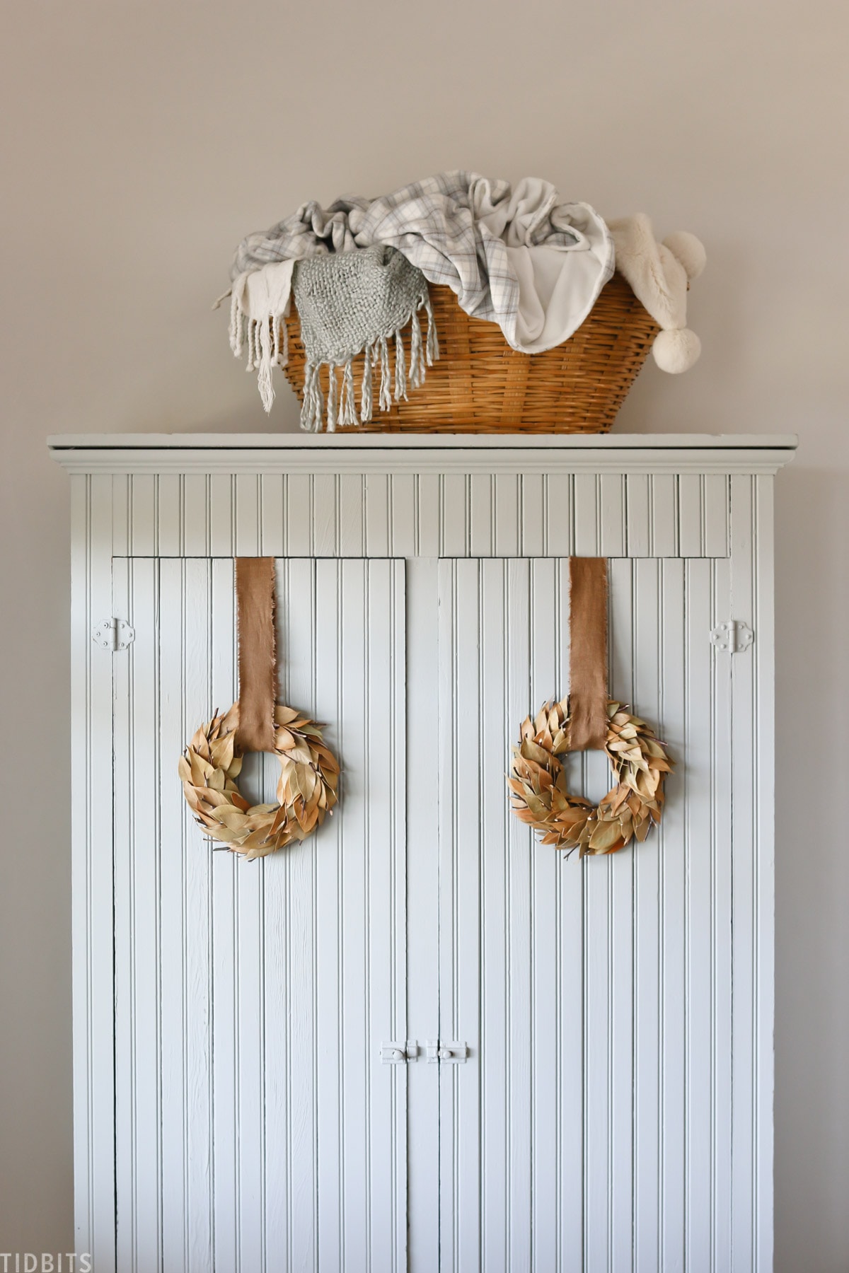 mini fall wreaths on a vintage cabinet