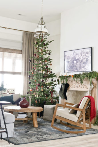 living room with European Old World Christmas decorations with arm chair, coffee table, and couch
