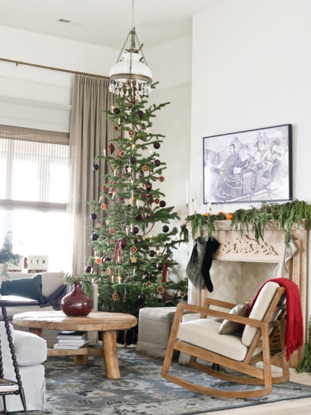 living room with European Old World Christmas decorations with arm chair, coffee table, and couch