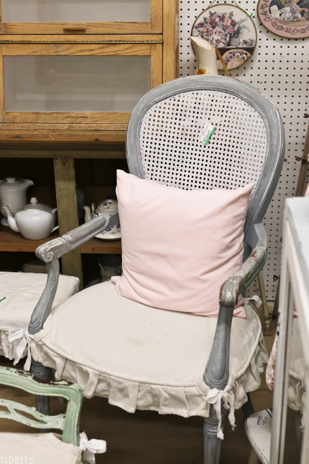antique chair with pink display pillow