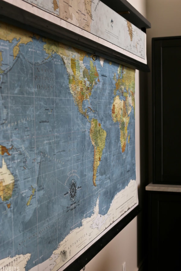 world map hanging up in homeschooling space behind a desk