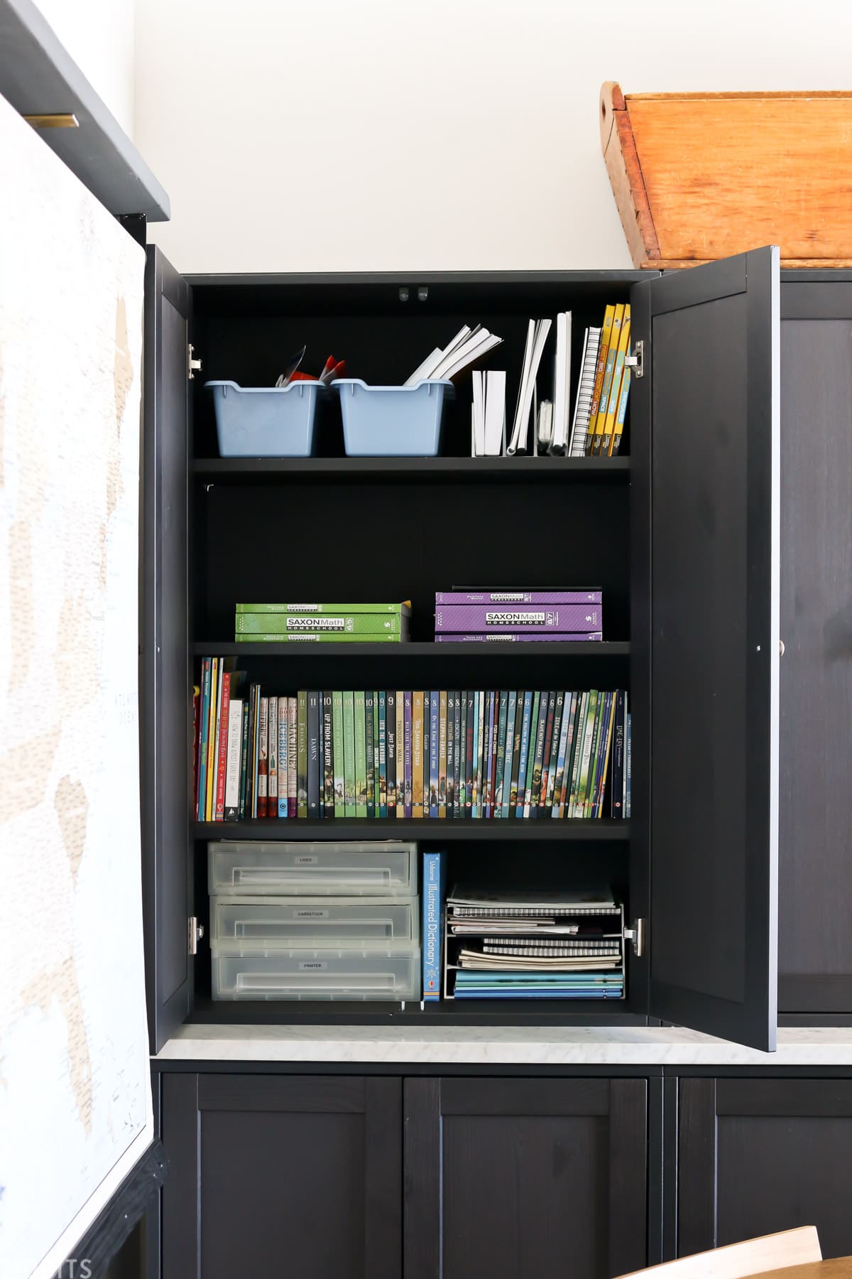 storage IKEA cabinet is filled with school supplies