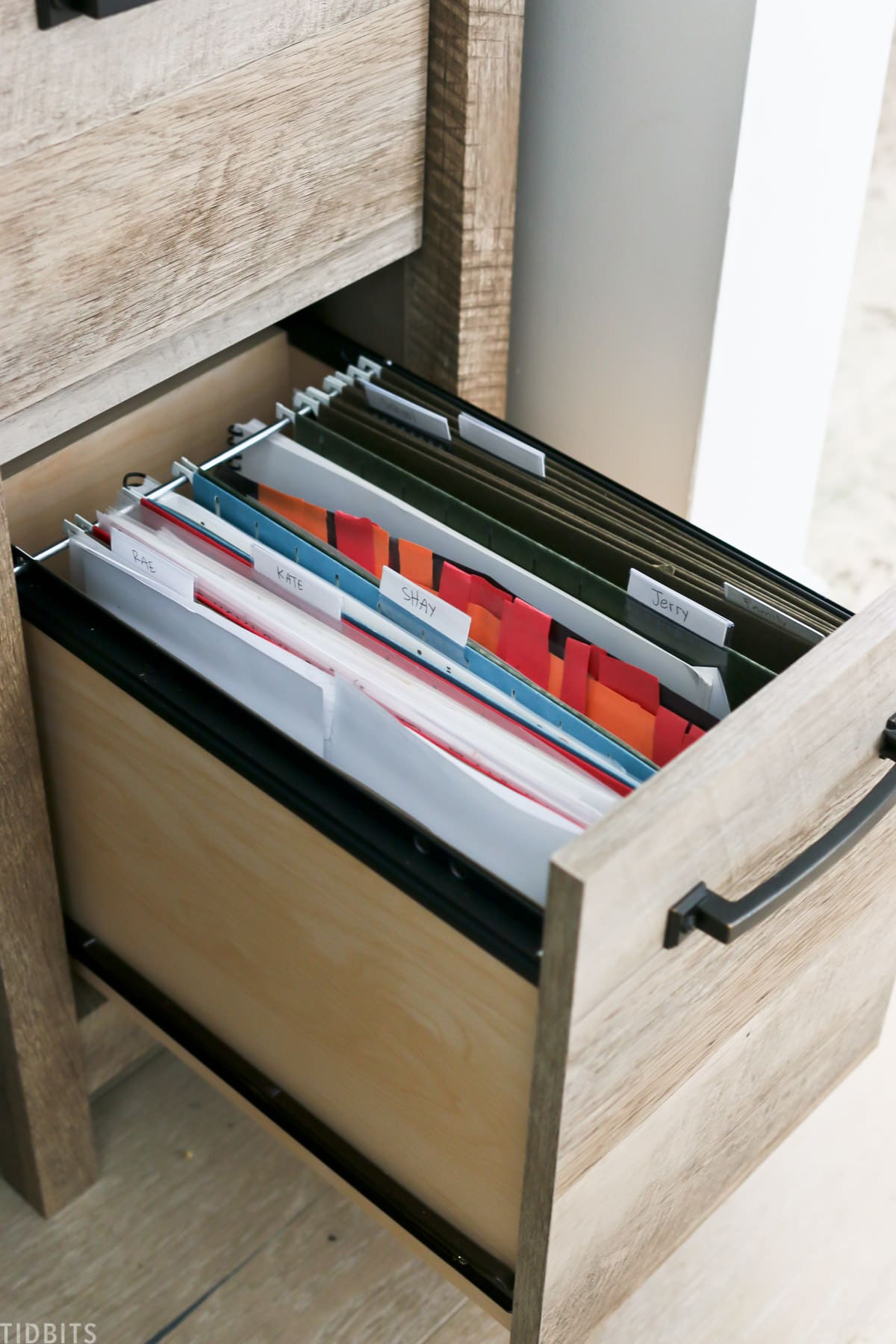 desk drawer is opened to reveal file folders