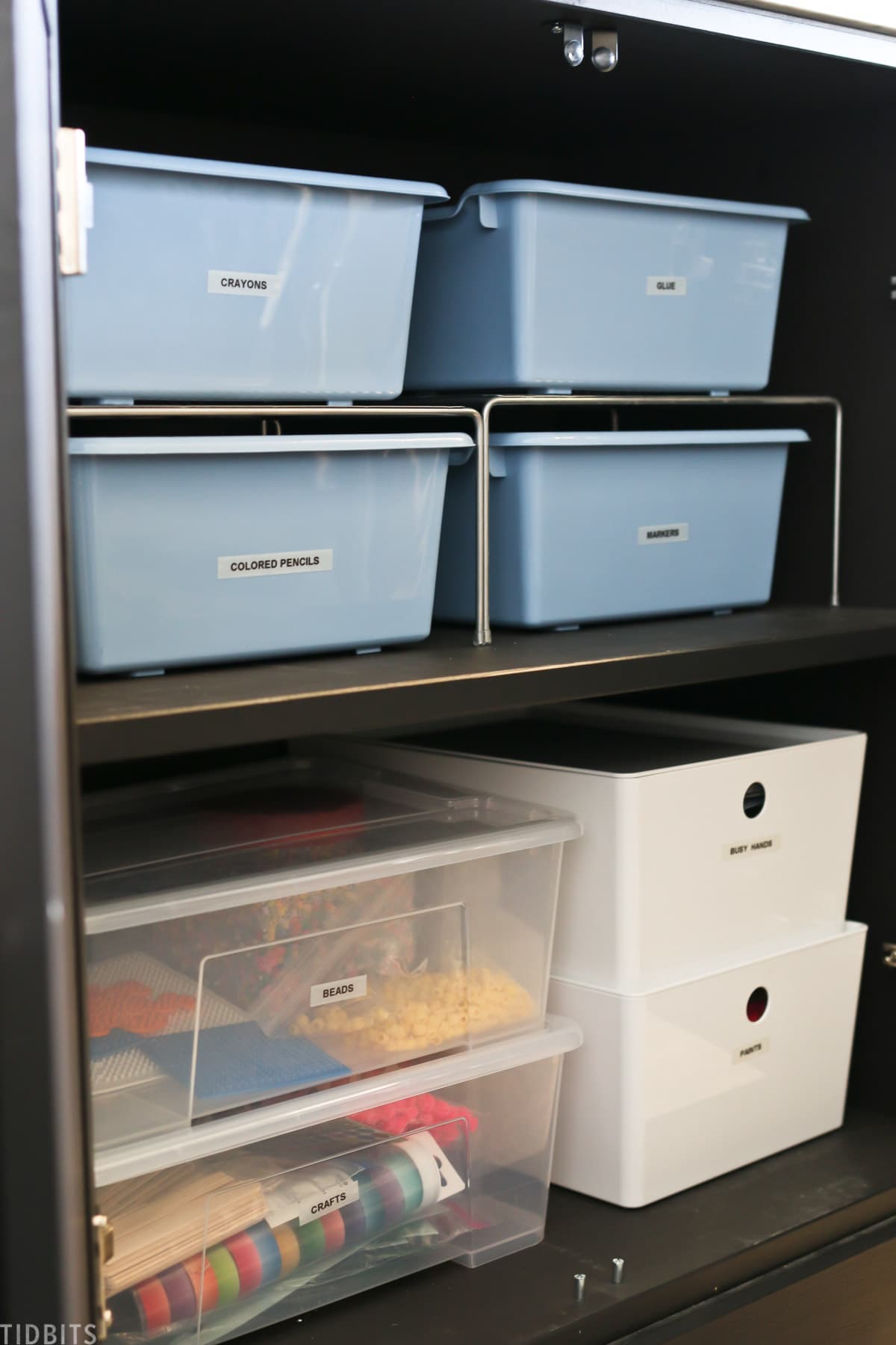 multiple containers with a label on each one indicating which office supplies they are storing