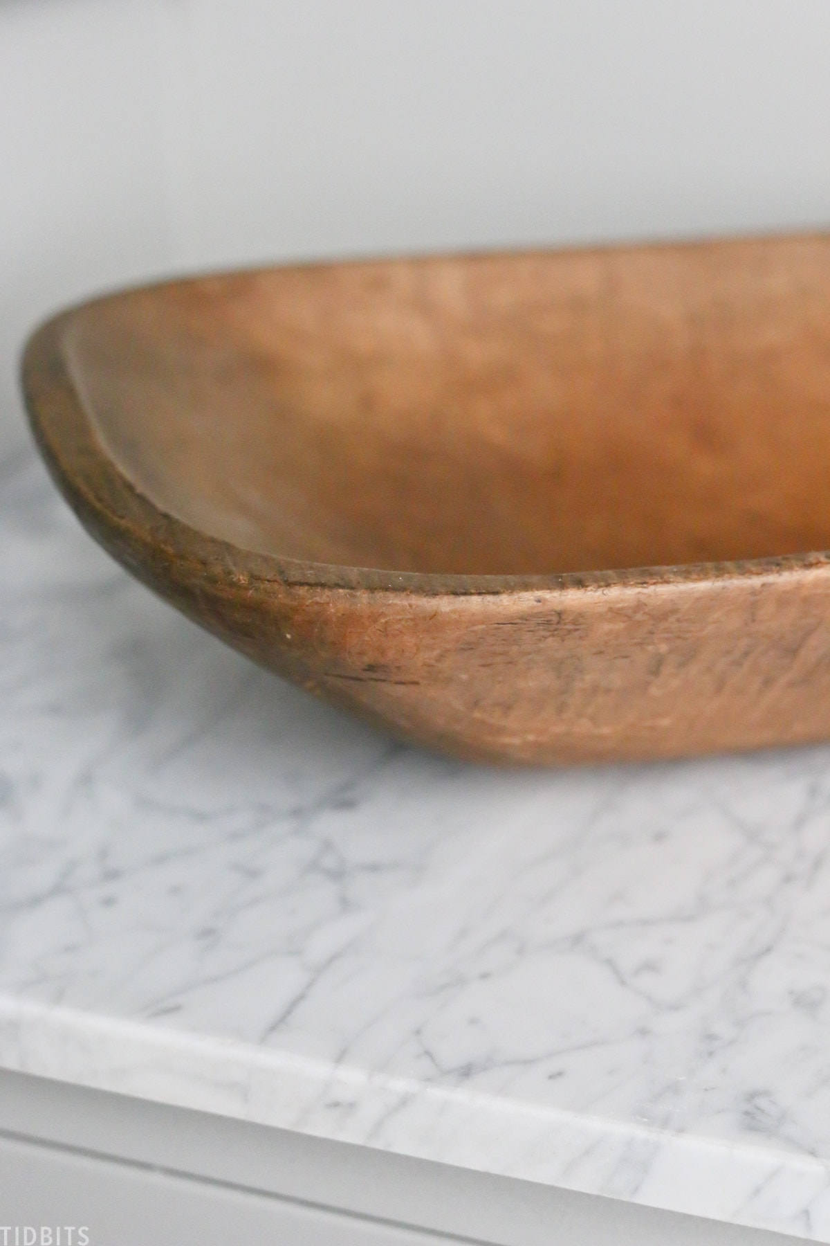 old wooden dough bowl on countertop