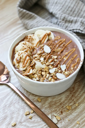 chocolate peanut butter smoothie bowl with banana slices and slivered almonds for garnish