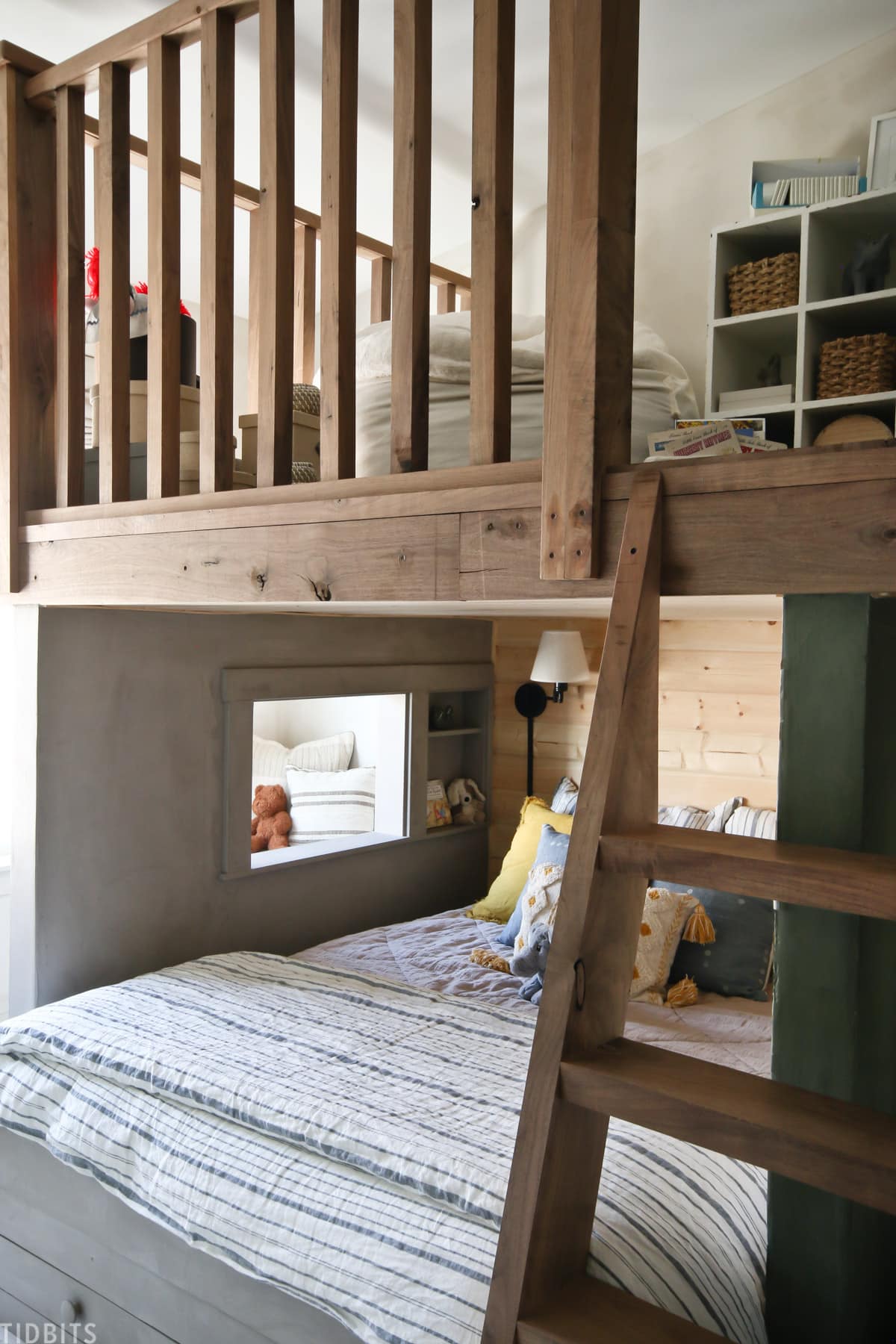 bedroom loft above two beds in a shared kids bedroom