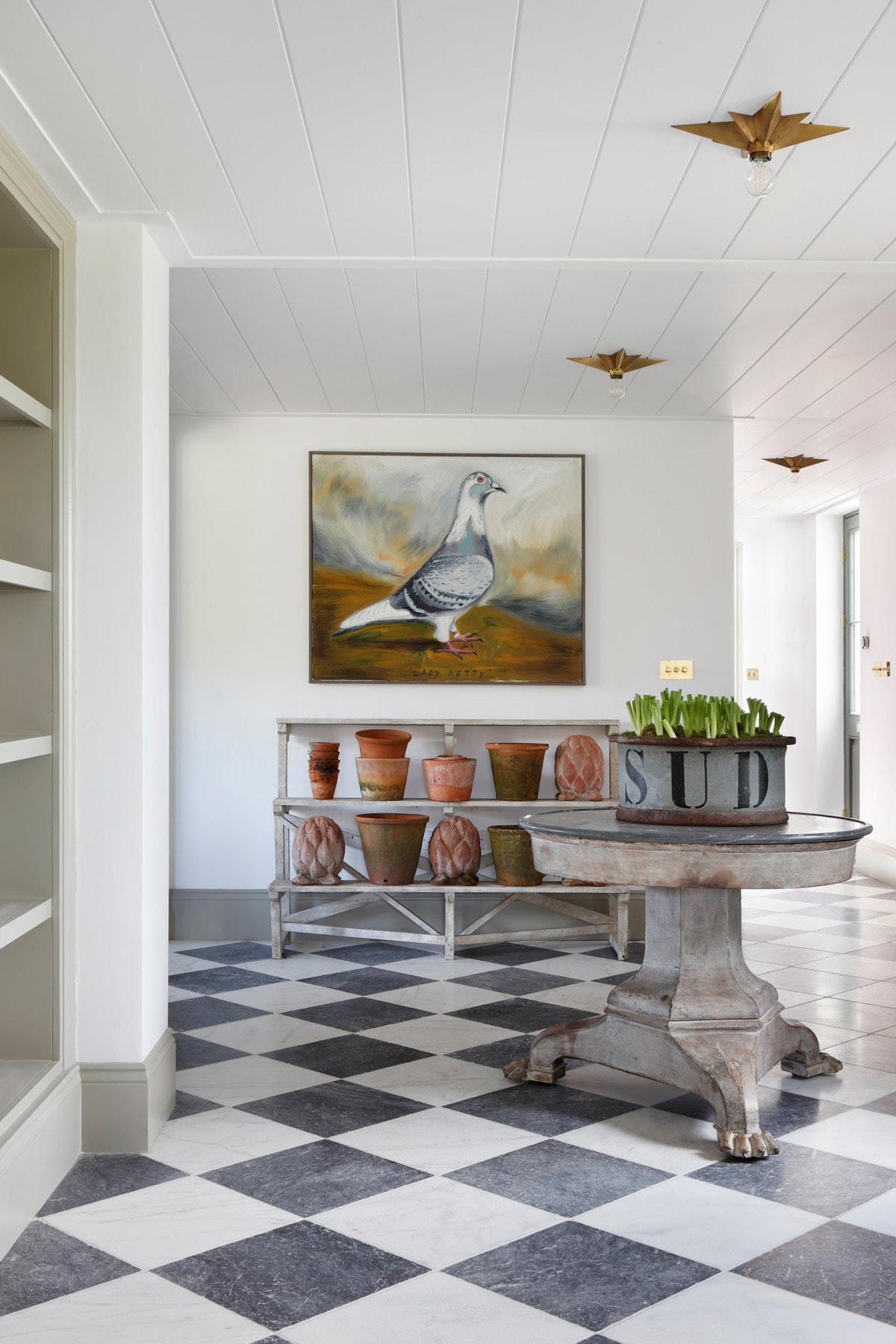 black and white checkerboard floor tile finishes with old-world furniture and home decor pieces