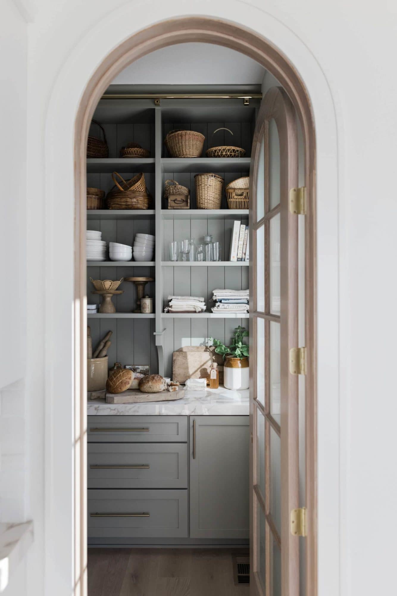 A BUTLER'S PANTRY WITH OPEN SHELVING