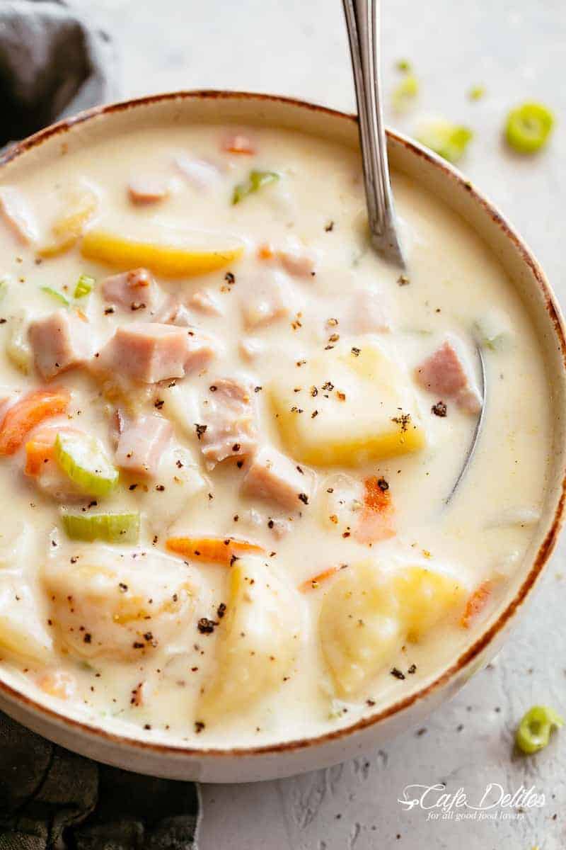 Bowl of creamy ham and potato soup with vegetables
