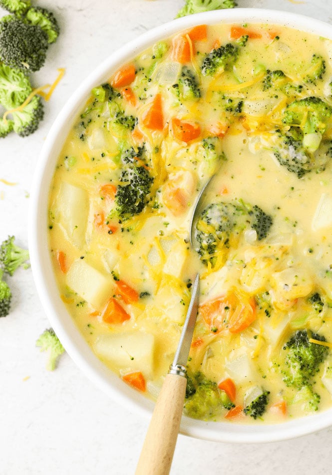 Spoon in a bowl of broccoli cheese and potato soup